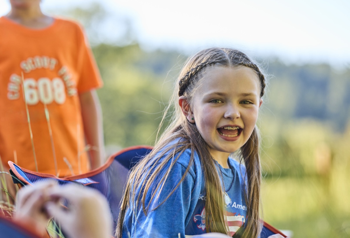 A happy Cub Scout at summer camp